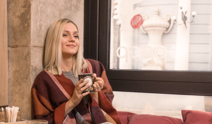 blonde woman on her period holding tea mug
